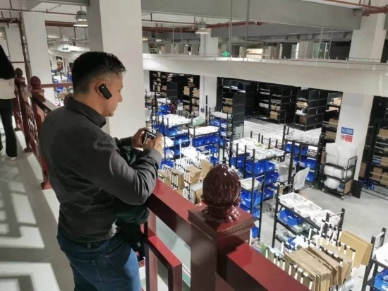 2023“一帶一路”媒體合作論壇聯(lián)合采訪團團員在仁和醫(yī)藥物流園拍攝記錄轉(zhuǎn)運流程。（本報記者 黃超攝）