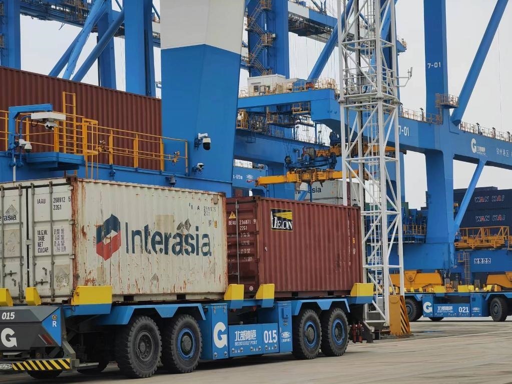 在欽州自動(dòng)化集裝箱碼頭，智能導(dǎo)引運(yùn)輸車在運(yùn)送集裝箱。新華社記者趙歡 攝