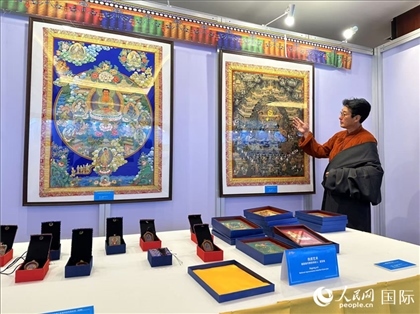 熱貢藝術(shù)國(guó)家級(jí)代表性傳承人夏吾角向嘉賓介紹作品。人民網(wǎng)記者 簡(jiǎn)承淵攝