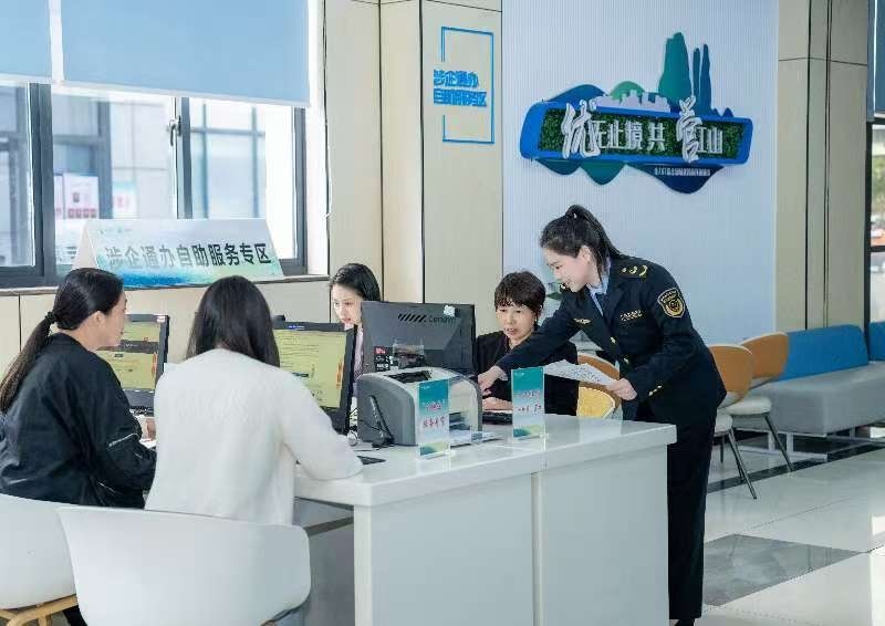 工作人員指導(dǎo)企業(yè)一次性完成信息填報(bào)。圖片來源：浙江衢州市市場(chǎng)監(jiān)督管理局