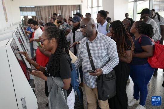 5月31日，在蒙內(nèi)鐵路內(nèi)羅畢站，乘客在自助取票機(jī)前排隊(duì)取票。新華社記者 楊光 攝